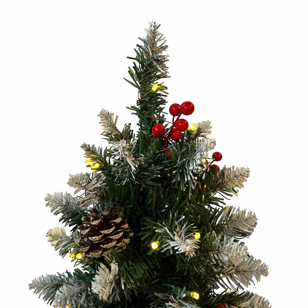 Decorated Christmas tree with lights, pinecones, and red berries