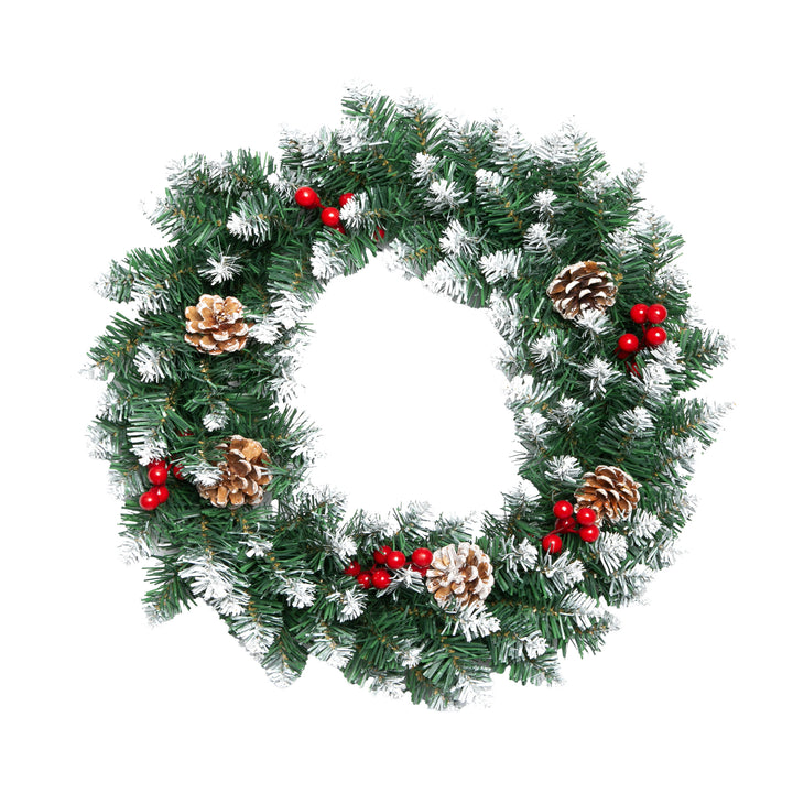 Christmas wreath with greenery, red berries, and pinecones