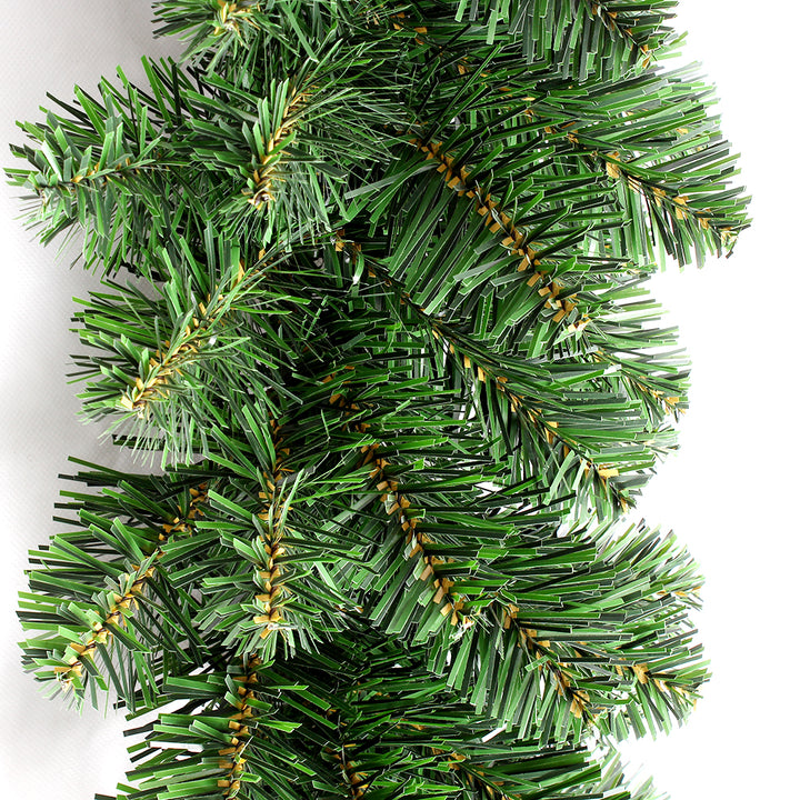 Close-up of a green artificial Christmas tree branch