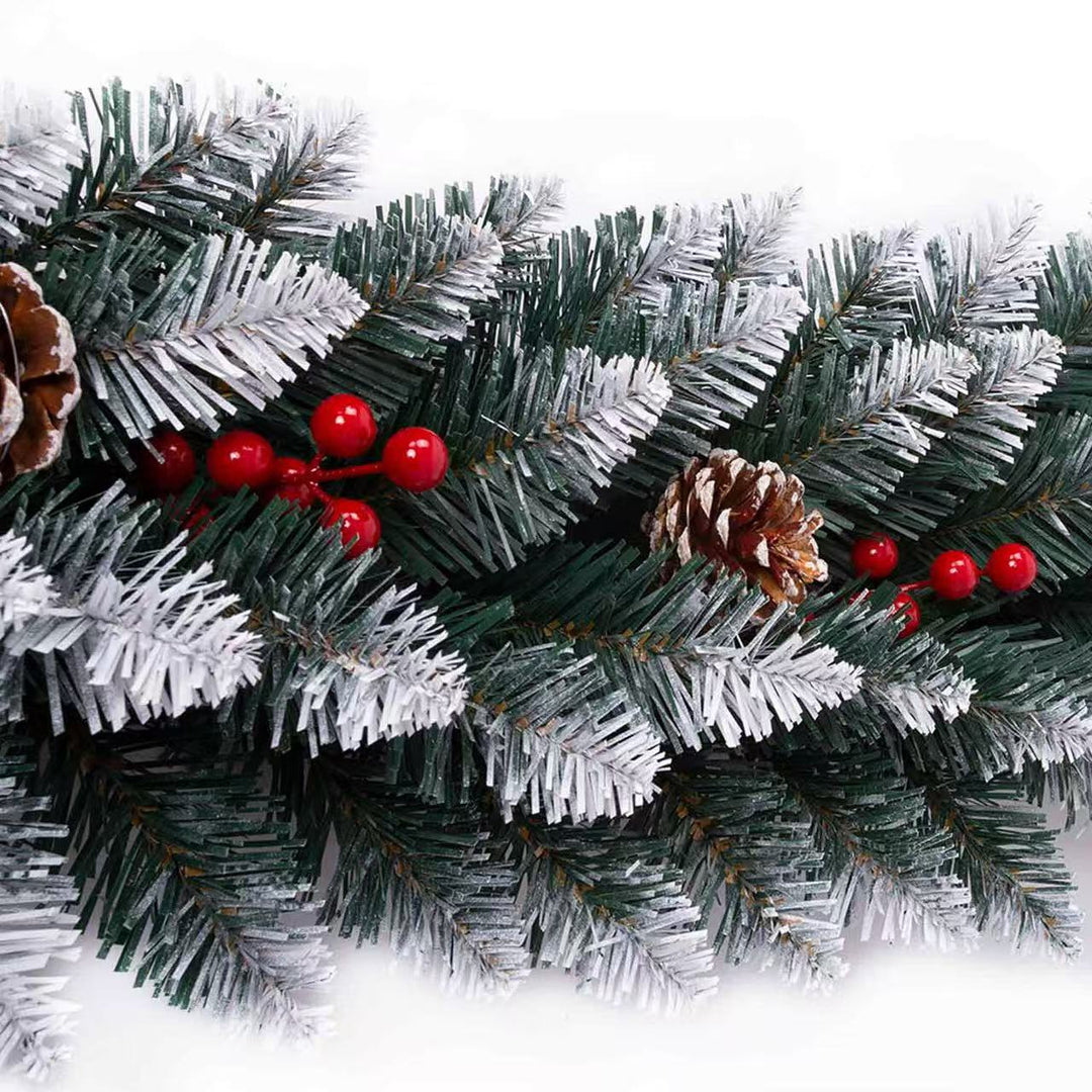 Christmas garland with green pine branches, red berries, and pine cones