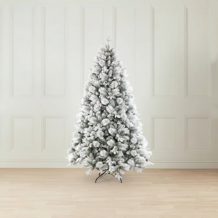 Frosted Christmas tree in a room with white paneled walls and wooden floor.