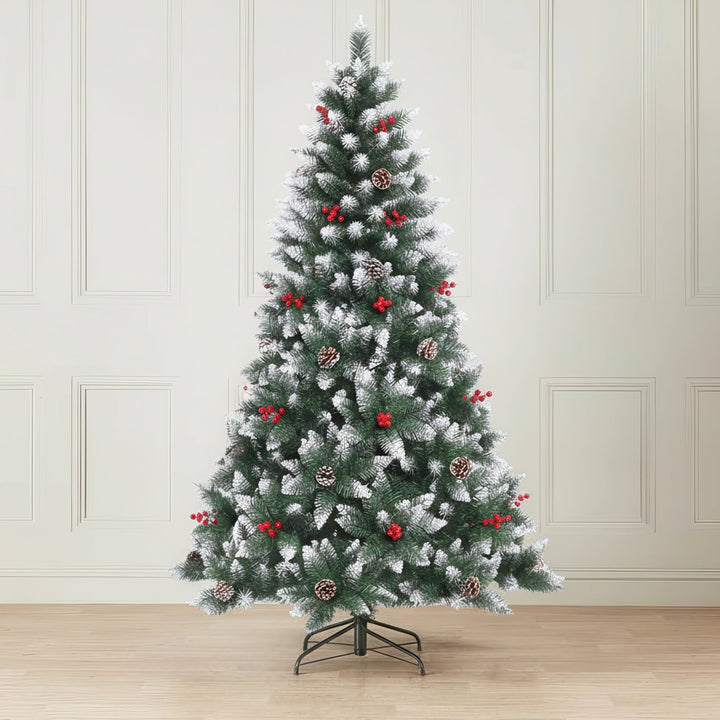 Decorated Christmas tree with red ornaments in a room with white paneled walls and wooden floor.