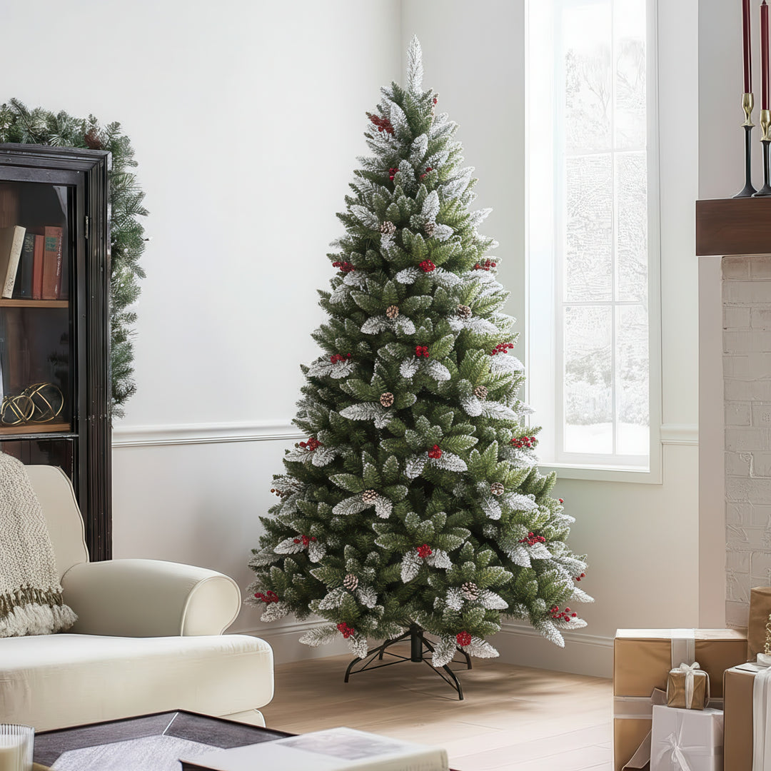 Decorated Christmas tree with artificial snow and red berries