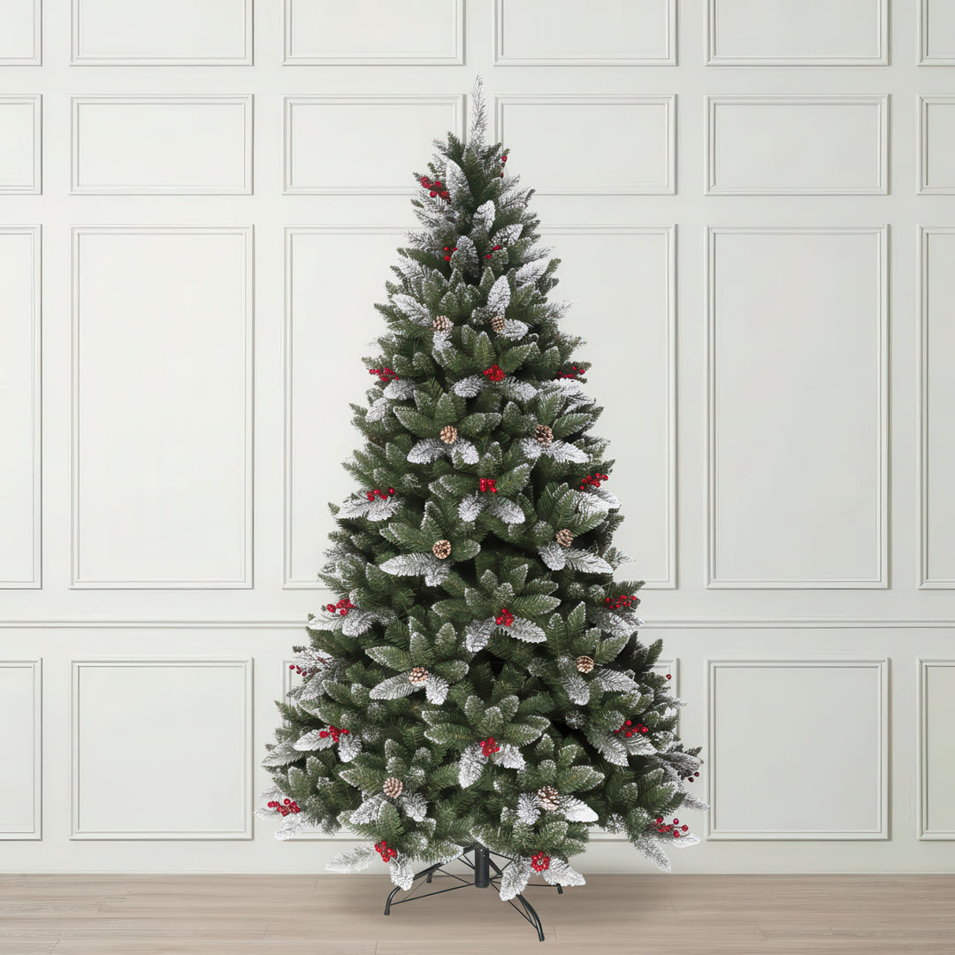 Decorated Christmas tree with artificial snow and red berries