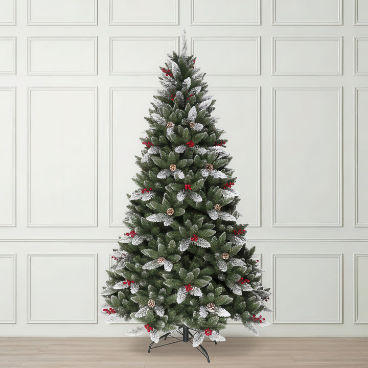 Decorated Christmas tree with artificial snow and red berries
