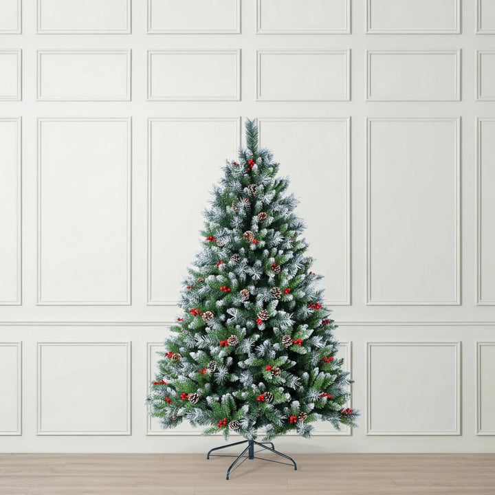 Decorated Christmas tree with green needles, red berries, and pinecones 